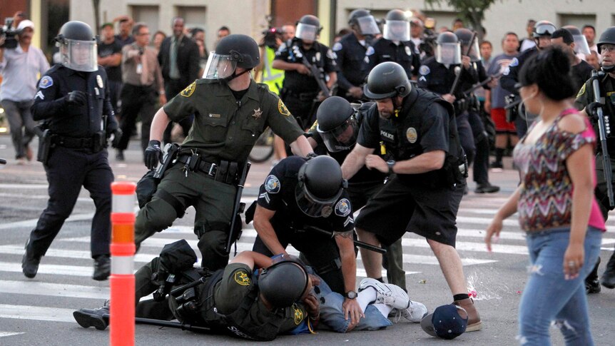 A protester is arrested by police officers in Anaheim.