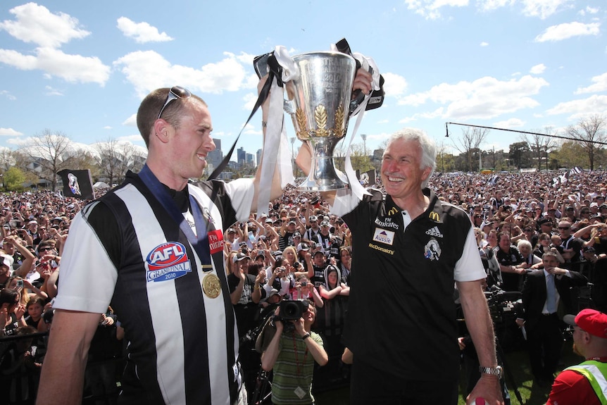Mick Matlhouse and Nick Maxwell celebrate Collingwood's 2010 AFL premiership with fans