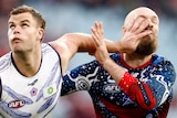 A Fremantle AFL player puts his left hand in the face of a Melbourne opponent.
