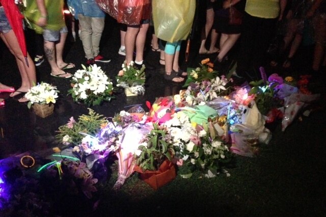 Flowers and glow sticks near murder scene