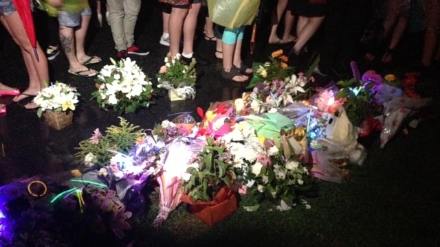 Flowers and glow sticks near murder scene