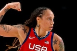 Brittney Griner flexes a bicep in a US basketball jersey 