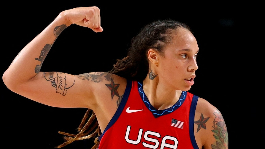 Brittney Griner flexes a bicep in a US basketball jersey 