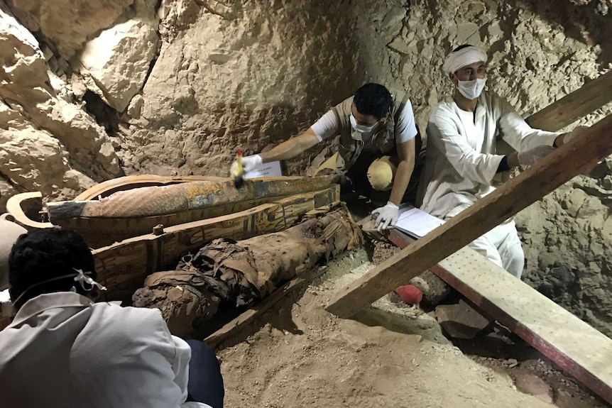 Workers are seen documenting their discoveries in the tomb of Userhat.