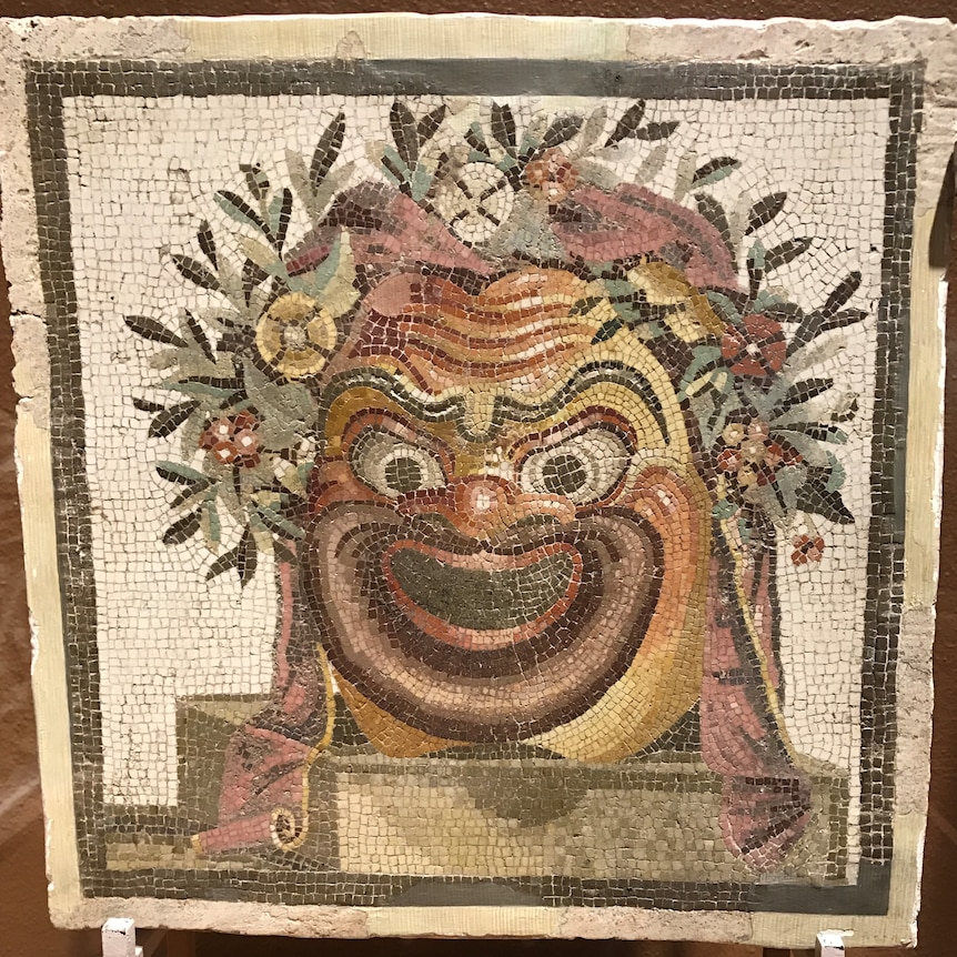 An ancient mosaic of a theatre mask