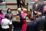 Kerryn Phelps and Julie Bishop hug in the house of representatives