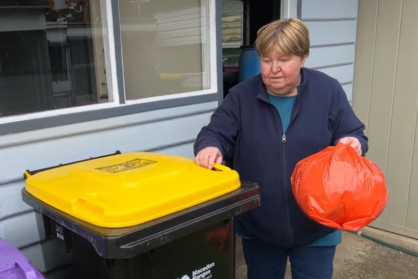 romsey resident valerie stannard places orange bag in recycling bin as part of soft plastics trial