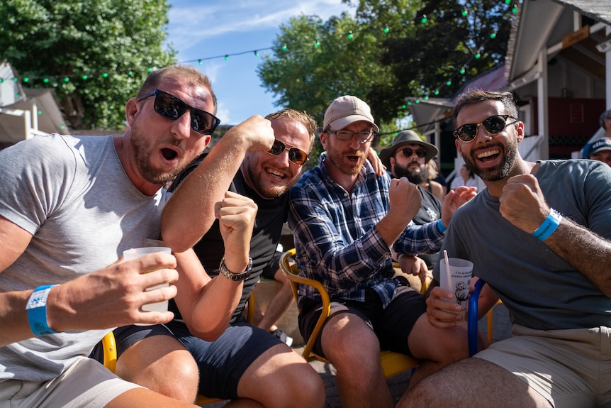 A group of men cheer on Nick Kyrgios at a London beer garden.