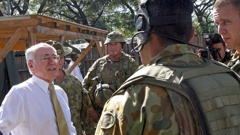 PM John Howard speaks to peacekeepers in Dili during a snap visit to East Timor.