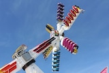 A colourful fun fair ride high in the air