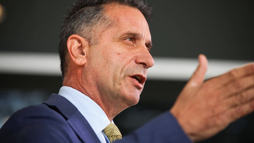 WA Police Minister Paul Papalia in side profile close up, gesturing with his hand.