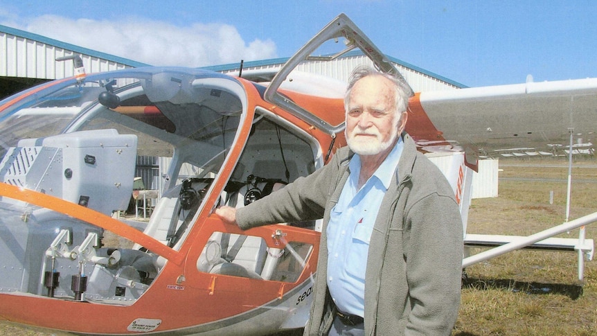 Don Adams standing in front of light aircraft