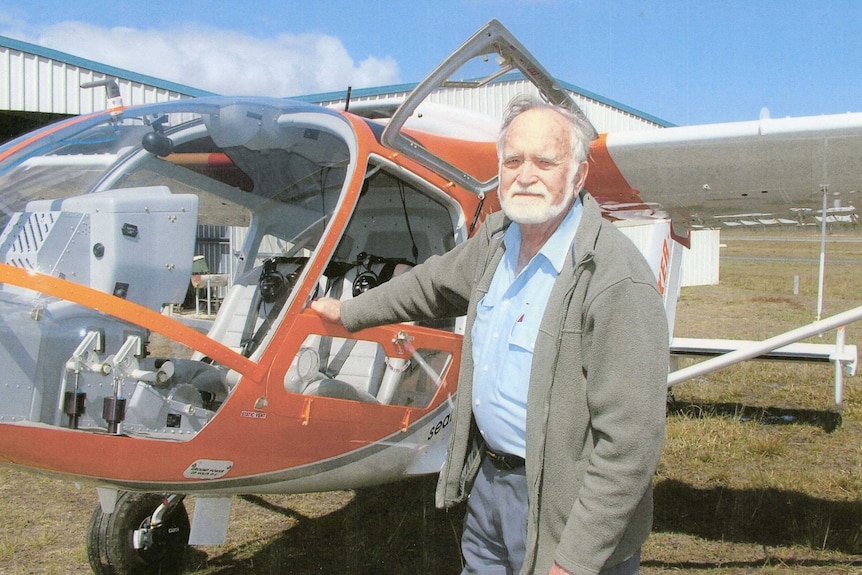 Don Adams standing in front of light aircraft