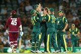 Australia's James Faulkner (C) is congratulated after bowling Chris Gayle of the West Indies.