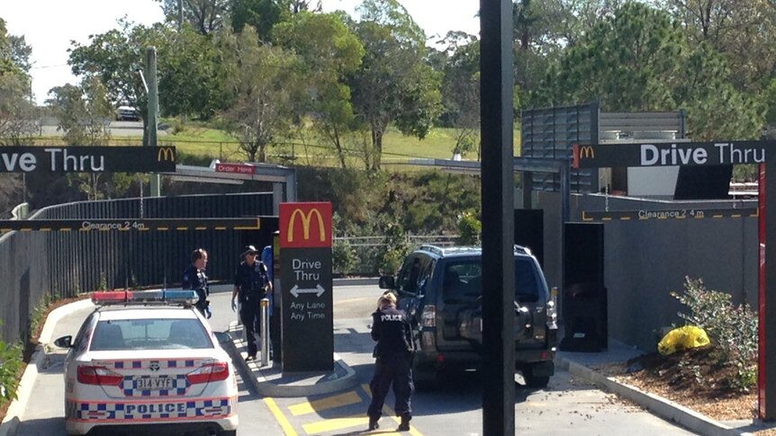 A traffic accident which escalated into a knife attack at a McDonald's has resulted in four people being stabbed.