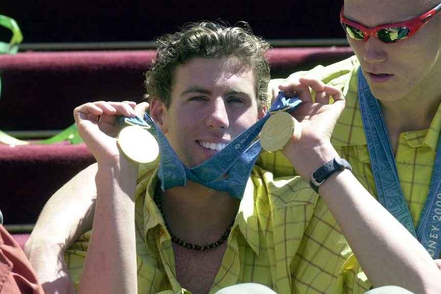 Grant Hackett showing off his Olympic medals at a parade following the 2000 Games.