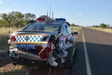 A police car sits on the side of the Stuart Highway after being rammed by a stolen car.