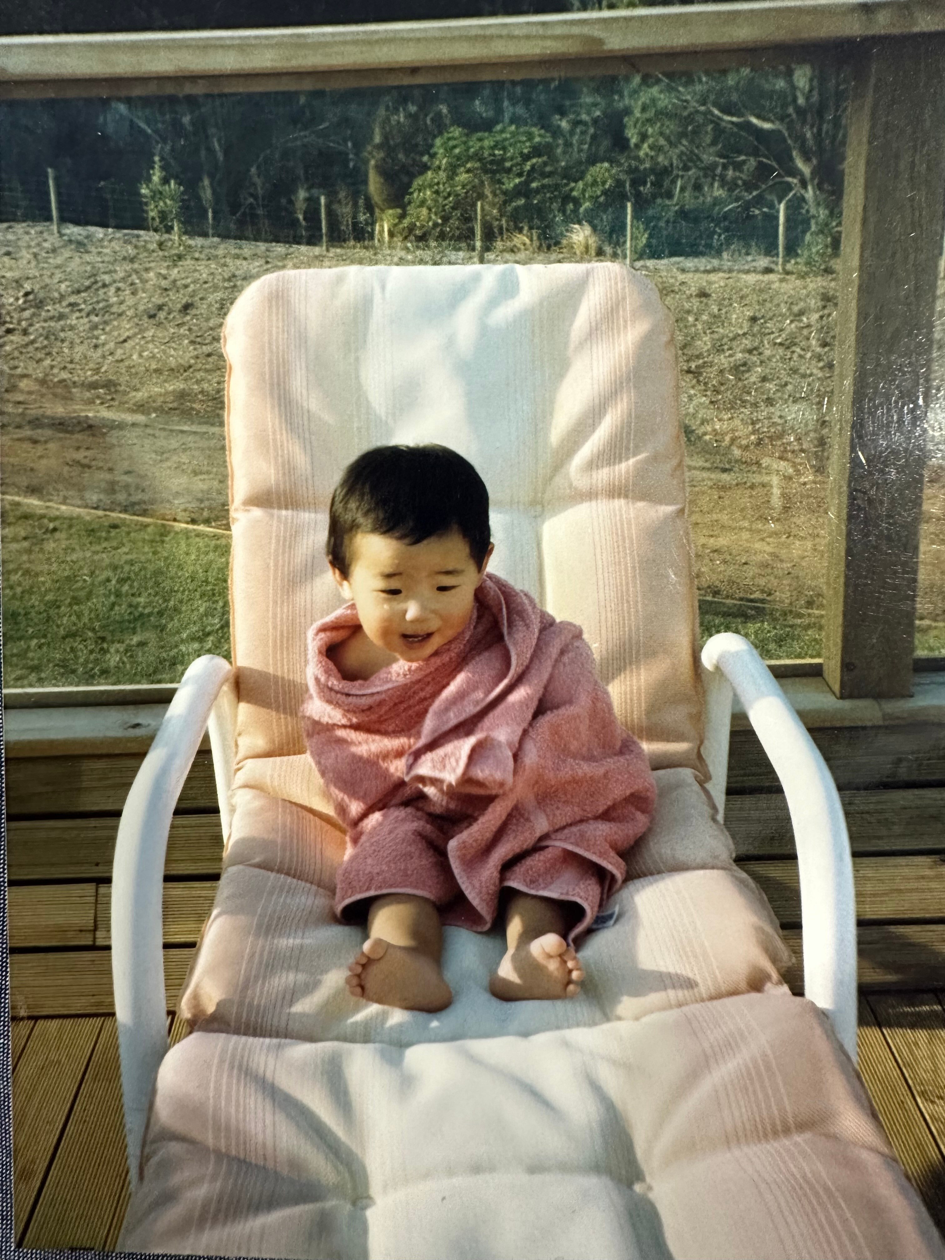 Matt Purcell as a toddler wrapped in a towel