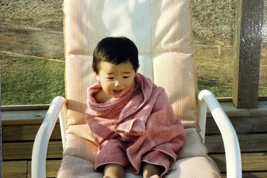 Matt Purcell as a toddler wrapped in a towel