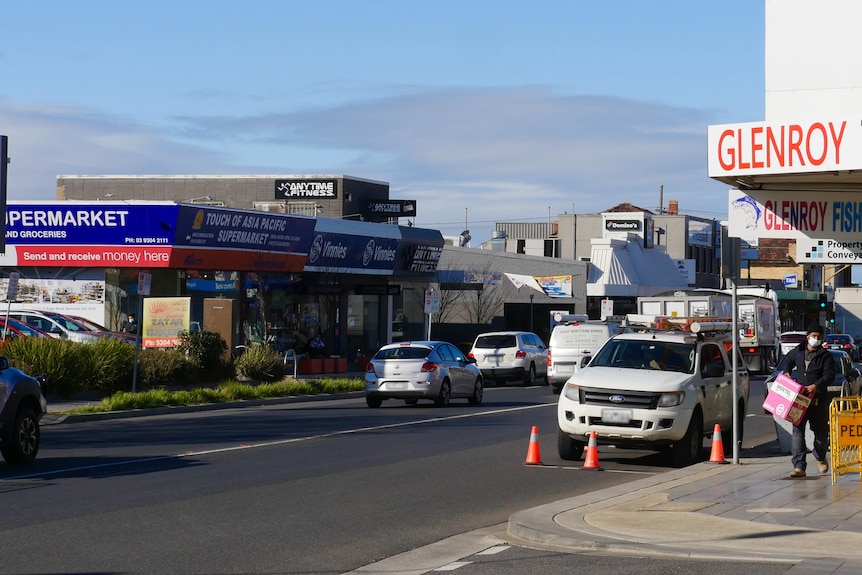 Cars drive up and down the suburban street of Glenroy on a sunny day.