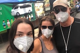 Selfie of Evie, Sharon, and Karl Radonich wearing facemasks on a Chiang Mai street in Thailand
