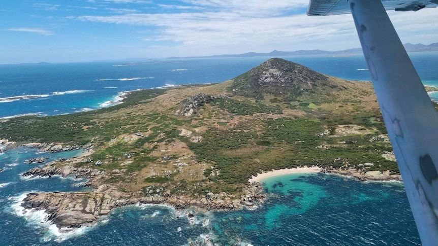 View of an island from the air with one mountain.