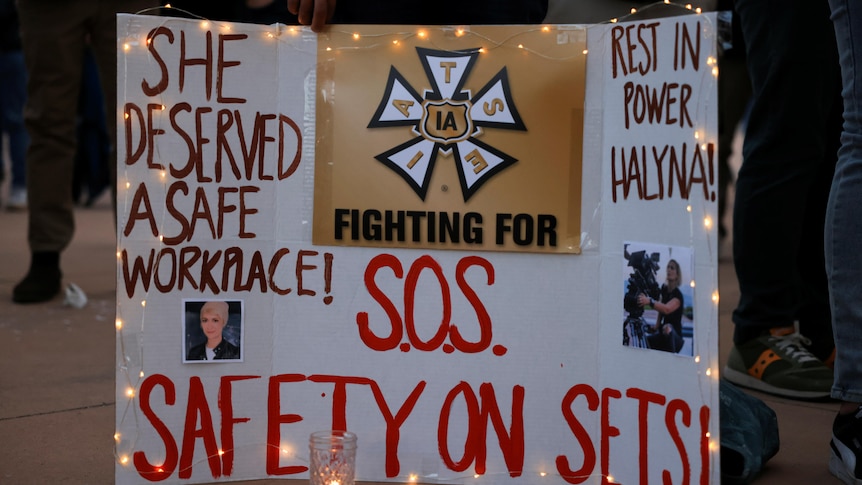 A sign calling for workplace safety at a vigil for cinematographer Halyna Hutchin