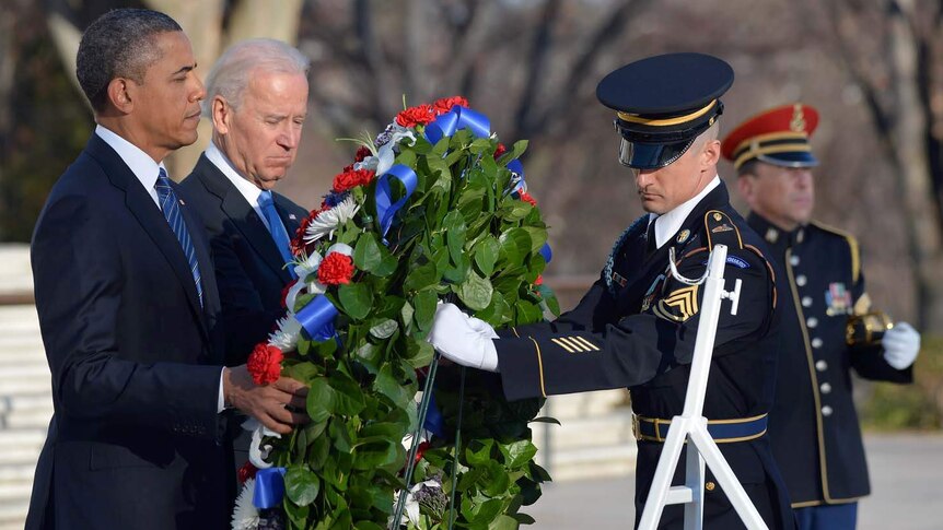 Barack Obama (left) and Joe Biden lay a wreath