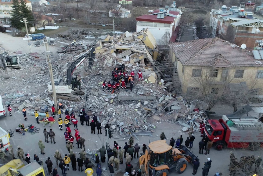 Rescuers work on a collapsed building after a strong earthquake struck in eastern Turkey.