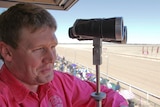 Josh Fleming watches the horses head out onto the racetrack ready to compete at the Birdsville Races