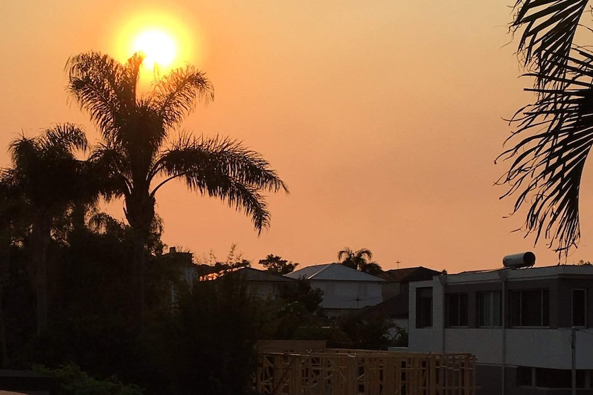 A golden sky over houses