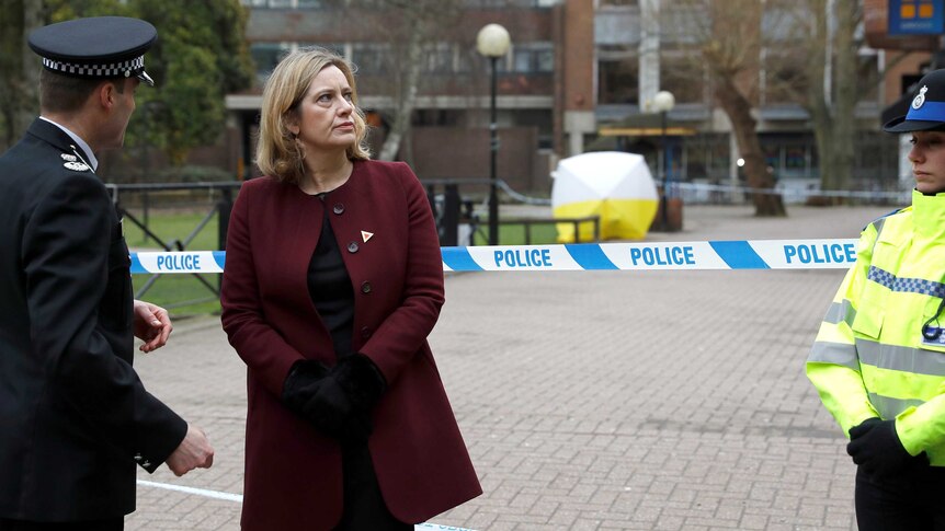 Amber Rudd stands in front of a police tape blocking off the scene where Sergei Skripal was found after being poisoned