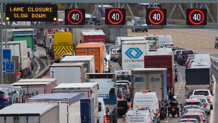 Cars and trucks banked up on a freeway in the UK.