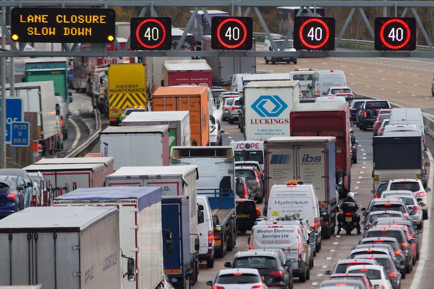 Cars and trucks banked up on a freeway in the UK.