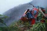 The wreck of a helicopter sits in the scrub on a Java mountain range.