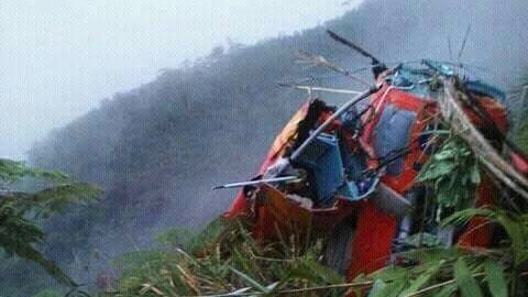 The wreck of a helicopter sits in the scrub on a Java mountain range.