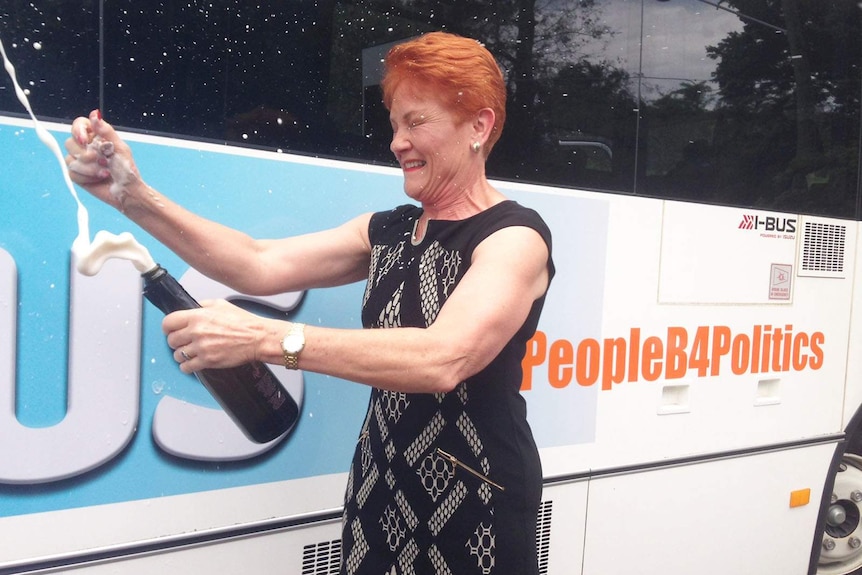 Pauline Hanson cracks open a bottle of champagne