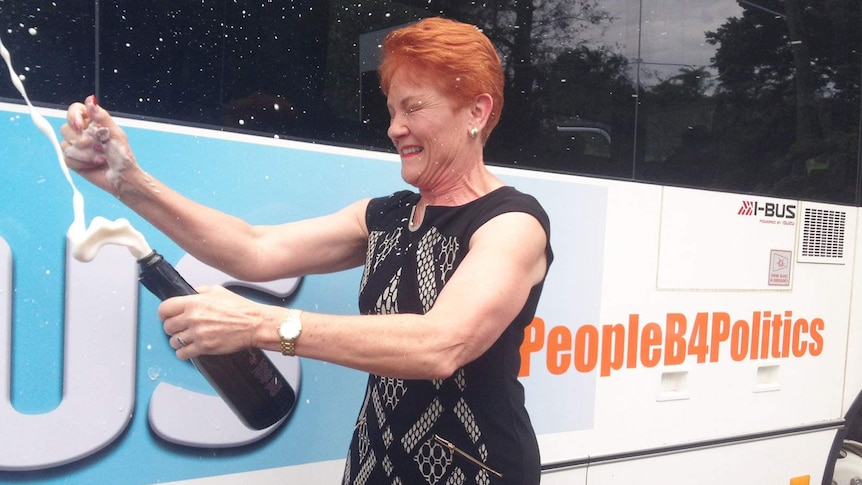 Pauline Hanson cracks open a bottle of champagne