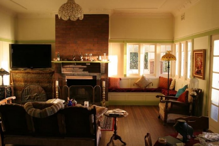 a furnished house with warm sunlight coming through the living room windows