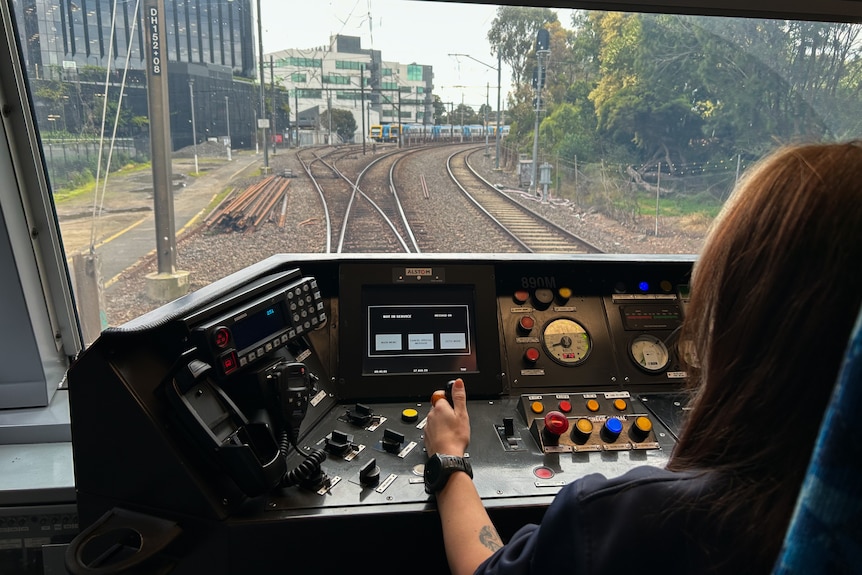A woman driving a train.