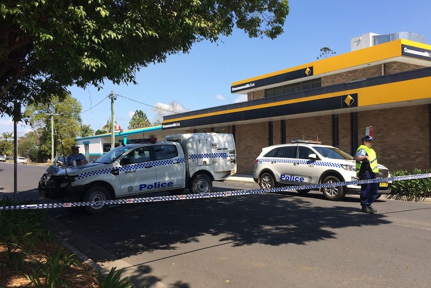 Police block off a road with cars and tape