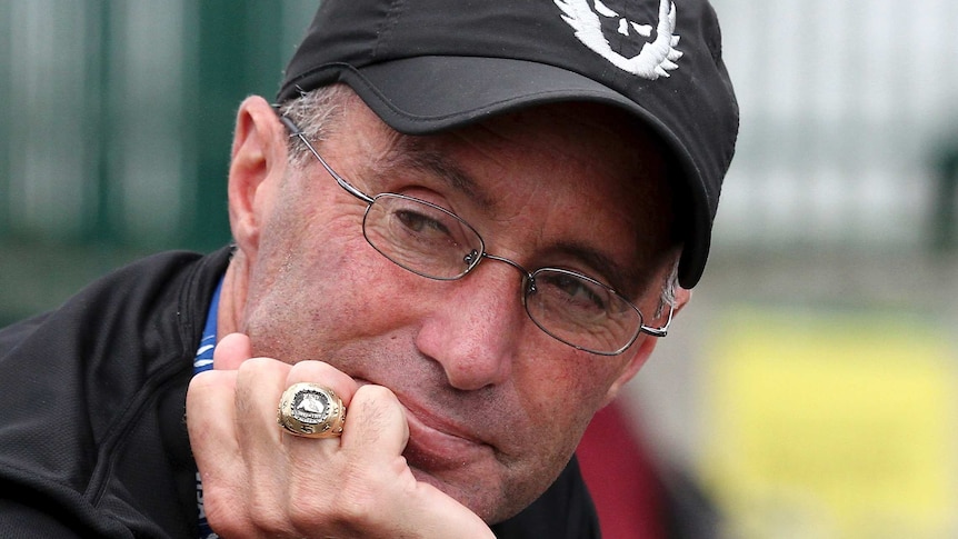 Alberto Salazar looks behind him with his chin resting on his hand