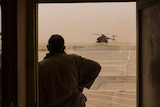 A silhouette of a man looking at a helicopter in Kunduz, Afghanistan.