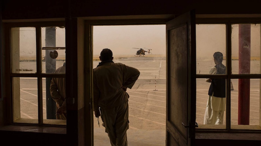 A silhouette of a man looking at a helicopter in Kunduz, Afghanistan.
