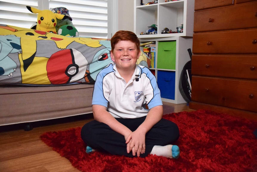 11-year-old Jacob James sits in his bedroom to depict family life with a father with younger onset dementia.
