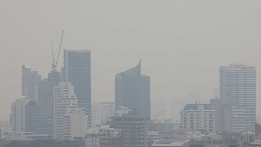 Bangkok's cityscape, which features several skyscrapers in this image, is covered in thick beige smog.