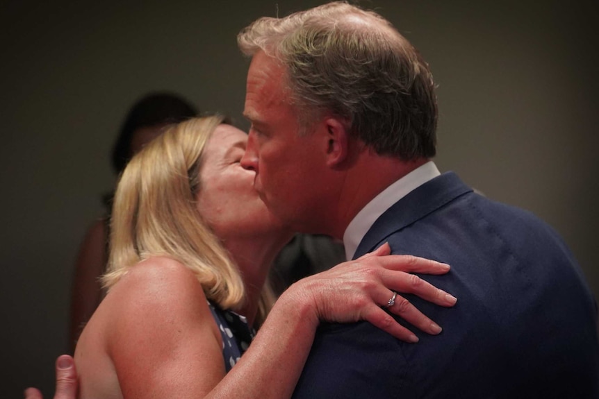 Will Hodgman kisses his wife, Nicola, on the cheek after announcing his resignation at a press conference.