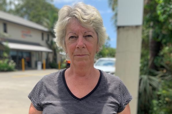 A woman in a striped shirt looked at the camera outside the caravan park