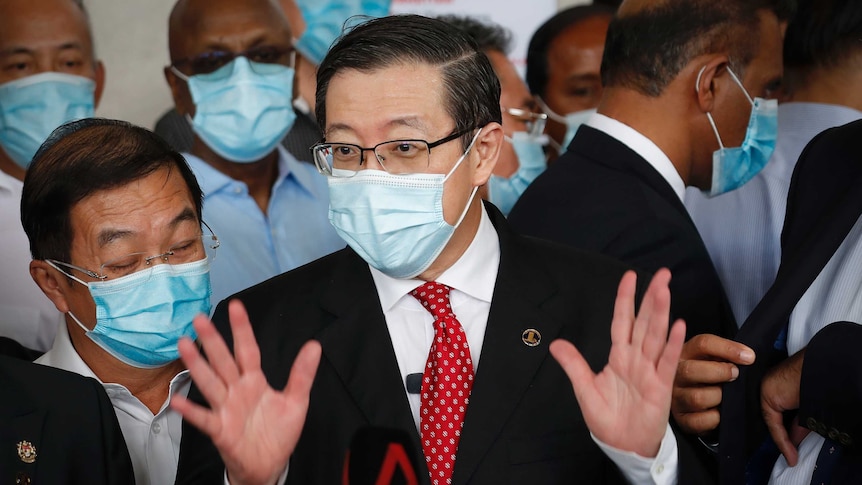 Lim Guan Eng, wearing a coronavirus mask, speaks to media outside court in Kuala Lumpur.