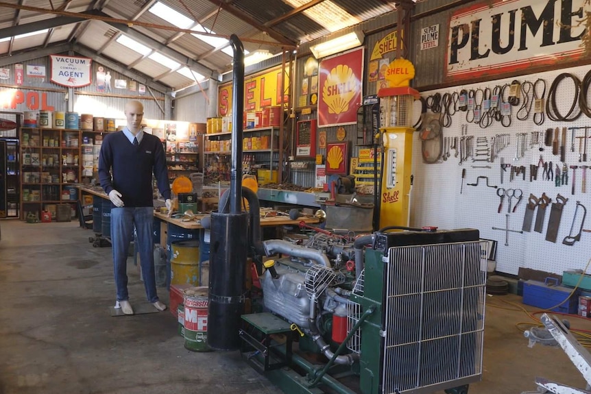 A large collection of tools, petrol signs and containers of oil.